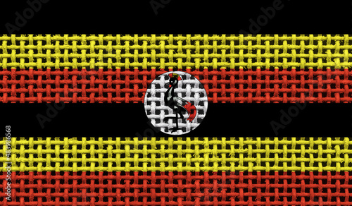 Uganda flag on the surface of a metal lattice. 3D image