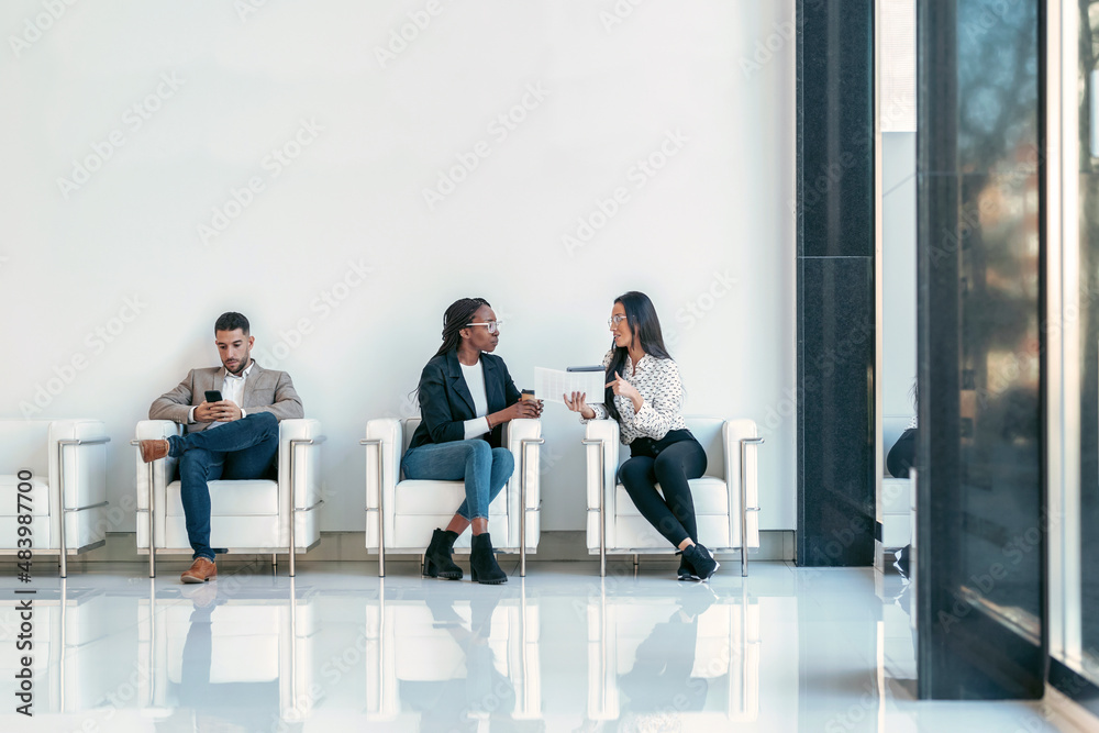 Beautiful businesswomen taking a break while cheaking her digital tablet sitting on armchairs in the lobby at modern startup. Beautiful businesswomen taking a break while cheaking her digital tablet sitting on armchairs in the lobby at modern startup.