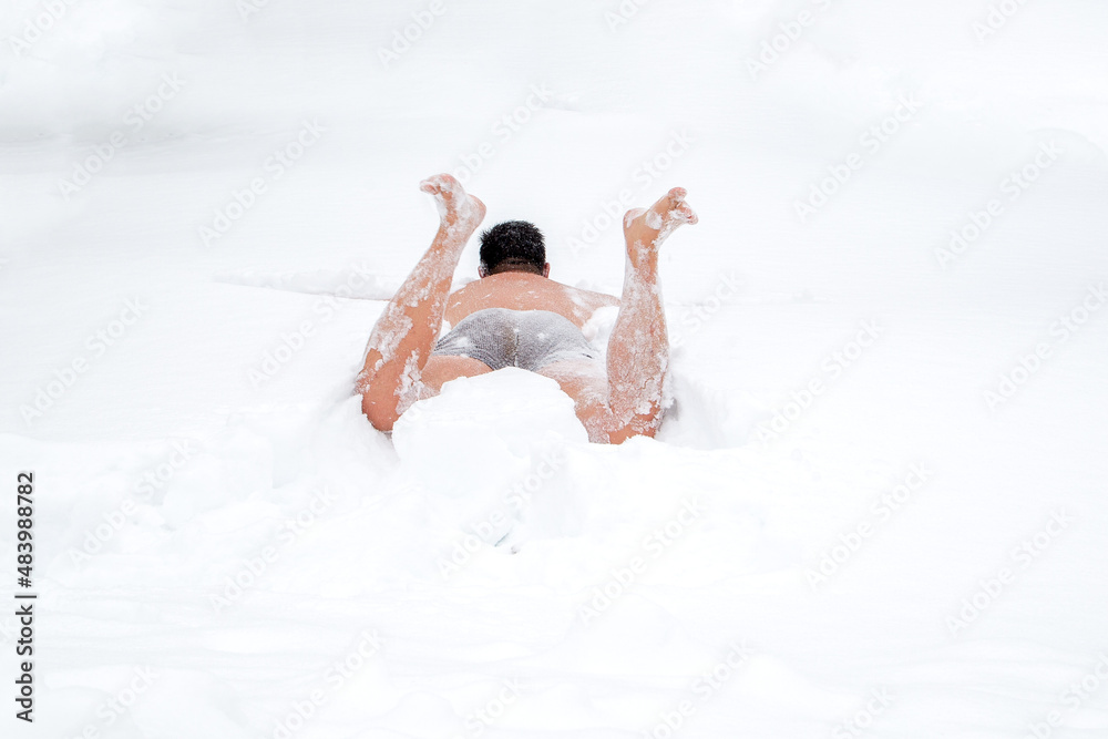a large man bathes in the snow after a hot bath