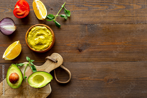Spicy guacamole avocado dip with herbs and tomatoes