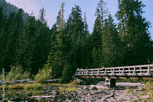 Hikers pose on a bridge over the outflow of Lake 22.