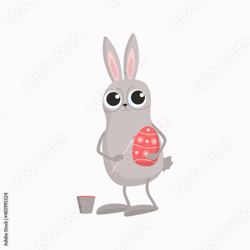 The Easter Bunny is painting an egg. Cartoon rabbit with brush  paint and egg. Easter holiday traditional attributes. Vector illustration with isolated background.