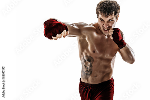 Portrait of aggressive boxer who training and practicing swing on white background. Red sportswear