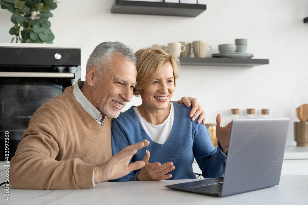 Positive spouses using laptop for video call Positive spouses using laptop for video call