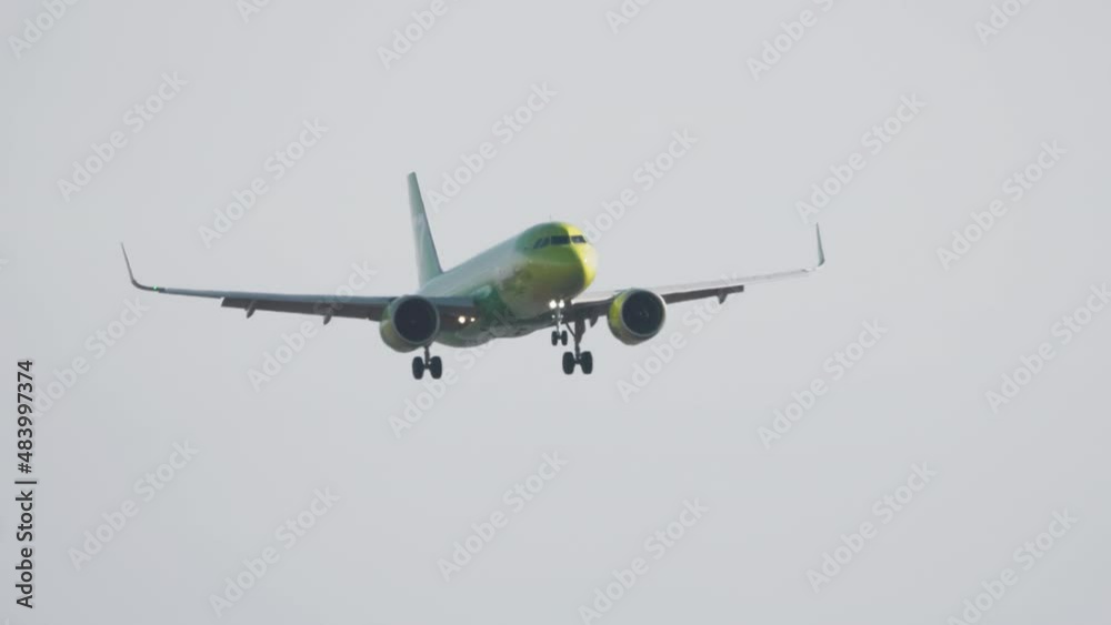 Jet passenger airplane landing to Dusseldorf airport (DUS). Airplane approaching, view from the end of the runway. Tourism and travel concept Jet passenger airplane landing to Dusseldorf airport (DUS). Airplane approaching, view from the end of the runway. Tourism and travel concept