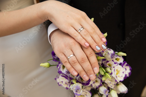 A pair of gold rings for wedding ceremony on bride and groom hands © protivnica
