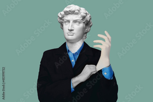 Abstract modern collage. The man with the plaster head of David in suit and blue shirt puts on medical glove on blue background