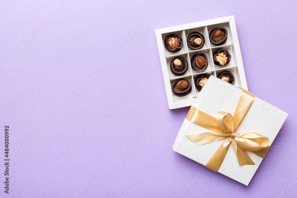 White box with chocolates candies and golden tape. top view with copy space White box with chocolates candies and golden tape. top view with copy space