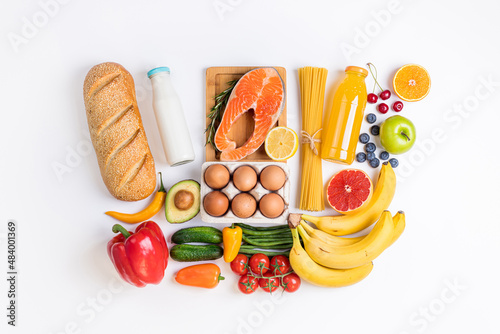 Healthy food background. Healthy food in shopping basket vegetables, fruits, fish, pasta on white. Shopping food supermarket, food delivery concept. Copy space photo