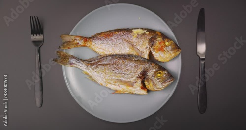 Closeup footage of serving whole grilled salt water fish photo