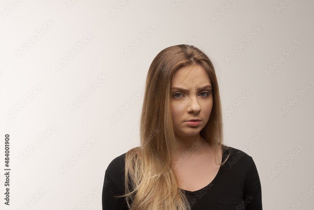 Portrait of sad young woman emotional alone in white background Portrait of sad young woman emotional alone in white background