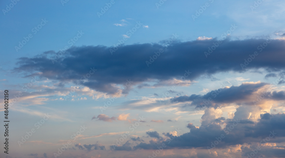 Twilight light color the cloudy sky. Cloud on blue sky background. Cloudscape grey and orange shade.