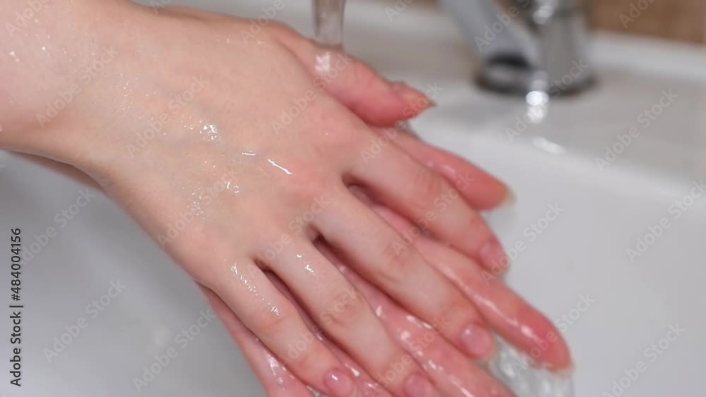 The girl washes her hands with soap. Hand disinfection. Slow motion. The girl washes her hands with soap. Hand disinfection. Slow motion.