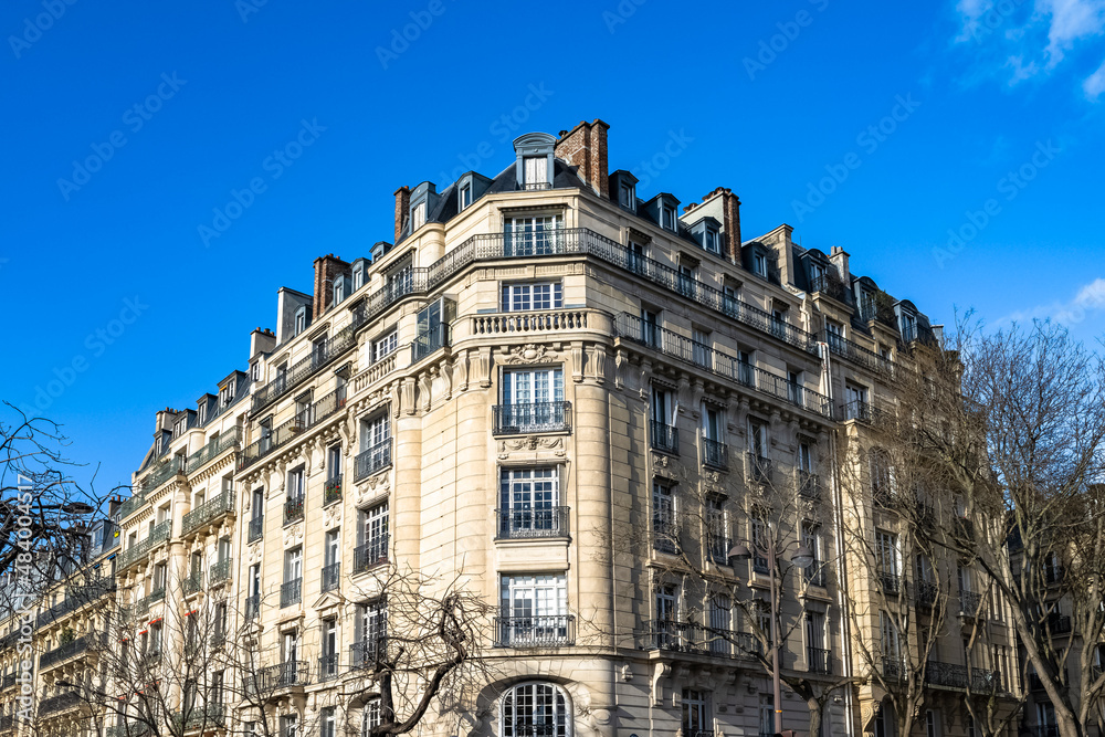 Paris, beautiful buildings, place Denfert-Rochereau in the 14e arrondissement, blue sky in winter

