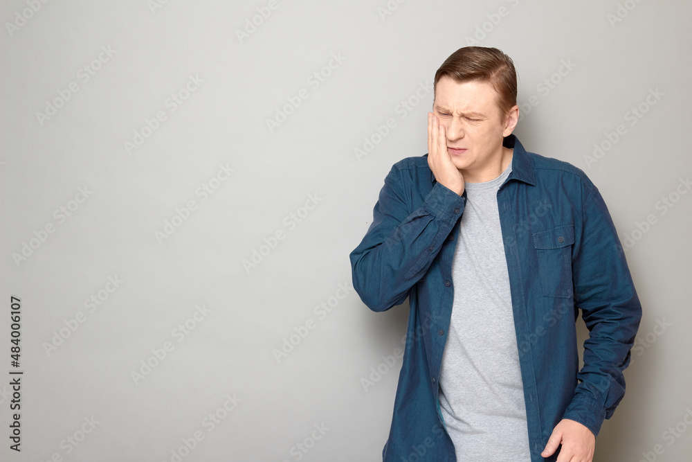 Portrait of unhappy man touching cheek and suffering from toothache Portrait of unhappy man touching cheek and suffering from toothache