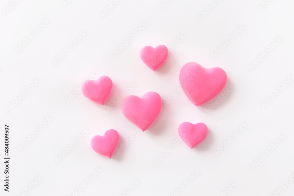 3d pink hearts creative arrangement on white background. Concept of love, romantic relationship, heart shape symbol, simple layout, celebration of  Valentine's Day, wedding background.