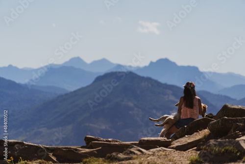 person sitting on a mountain top