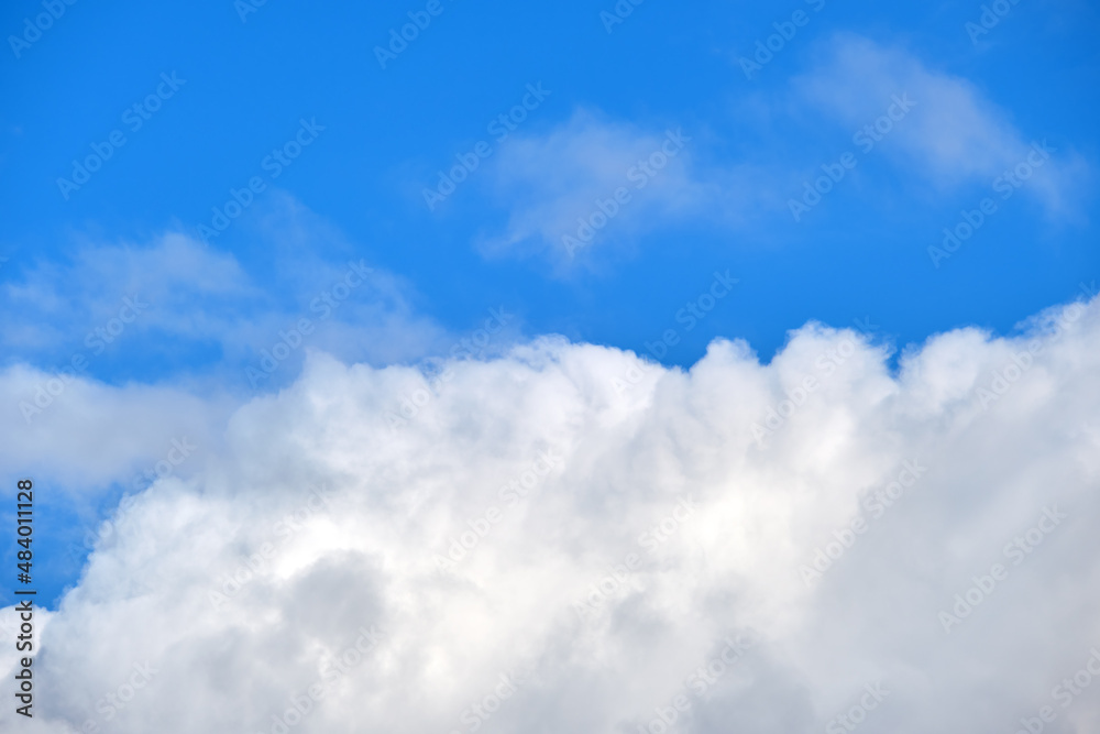 Bright landscape of white puffy cumulus clouds on blue clear sky Bright landscape of white puffy cumulus clouds on blue clear sky