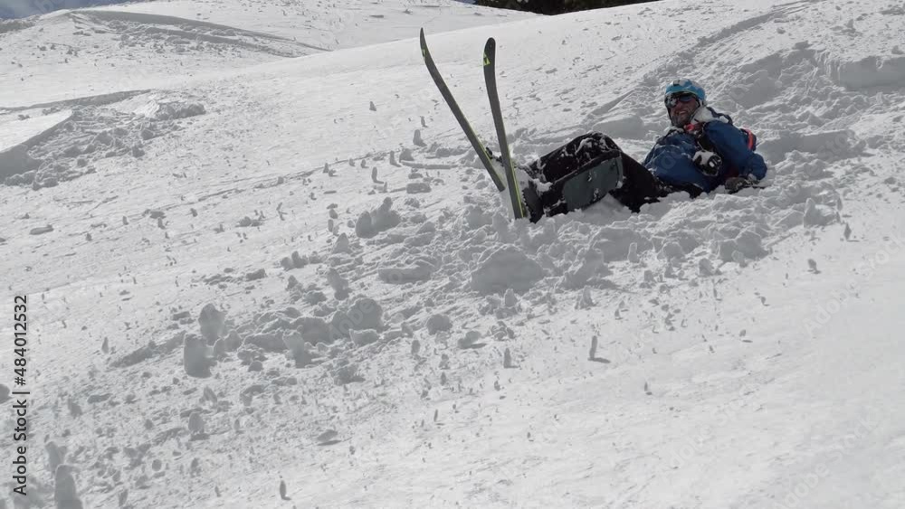 Unrecognizable Freestyle skier falling off-piste on fresh powder snow