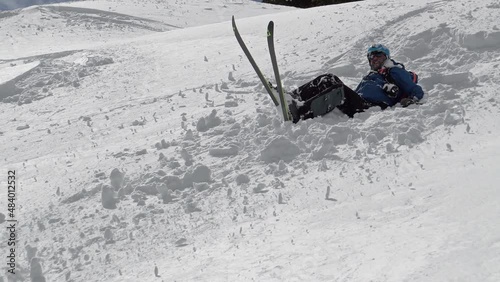 Unrecognizable Freestyle skier falling off-piste on fresh powder snow photo