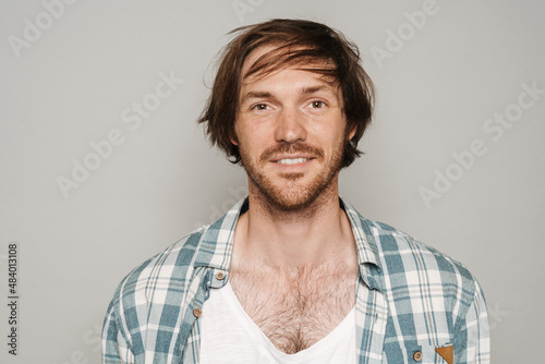 White unshaven man in shirt smiling and looking at camera