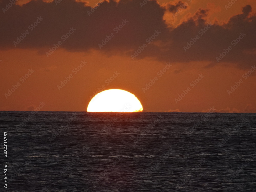 The sun sets over the sea