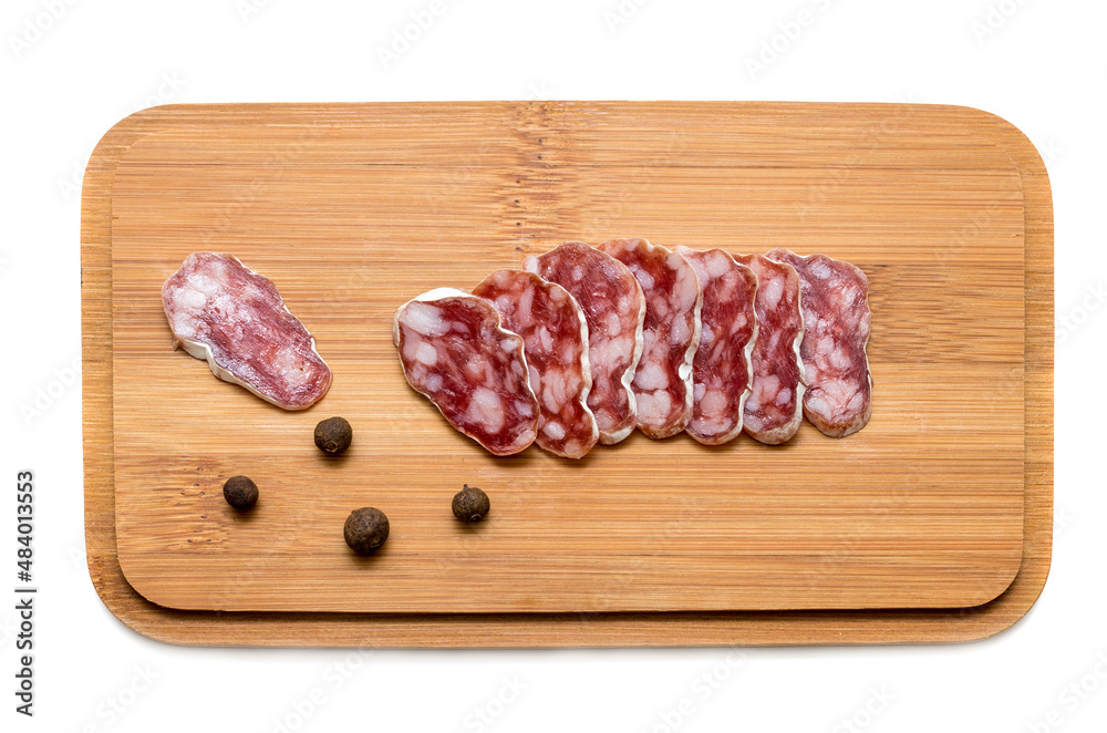 Smoked sausage cut on a wooden board with peppers isolated on white background Smoked sausage cut on a wooden board with peppers isolated on white background