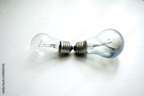 burned out and new light bulb on a white background, close-up