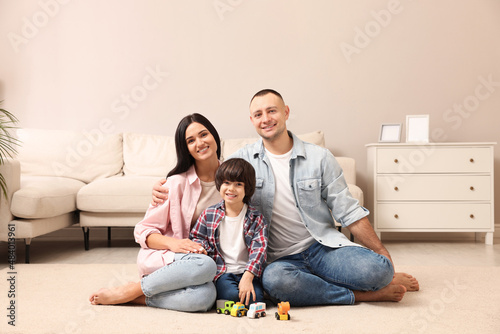 Happy family sitting on floor at home