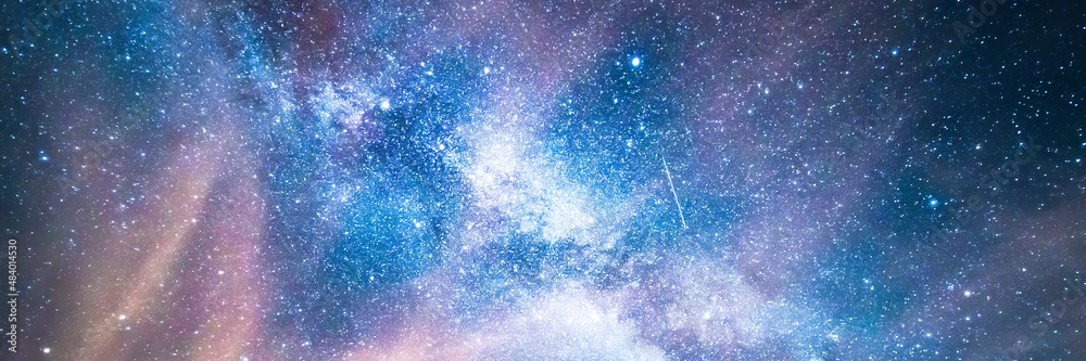 Milky way background with blue and purple colors