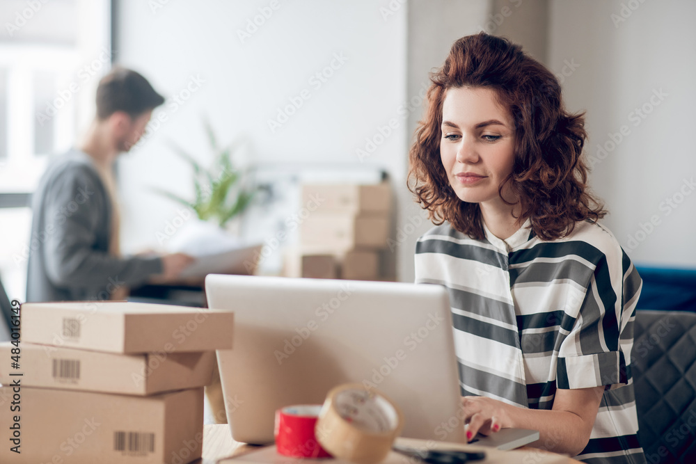 Two Internet shop workers working in the office Two Internet shop workers working in the office