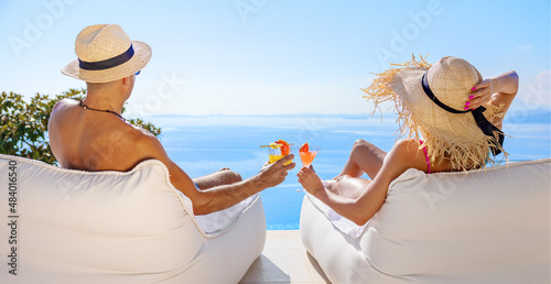 Couple holding cocktail classes while relaxing by the pool