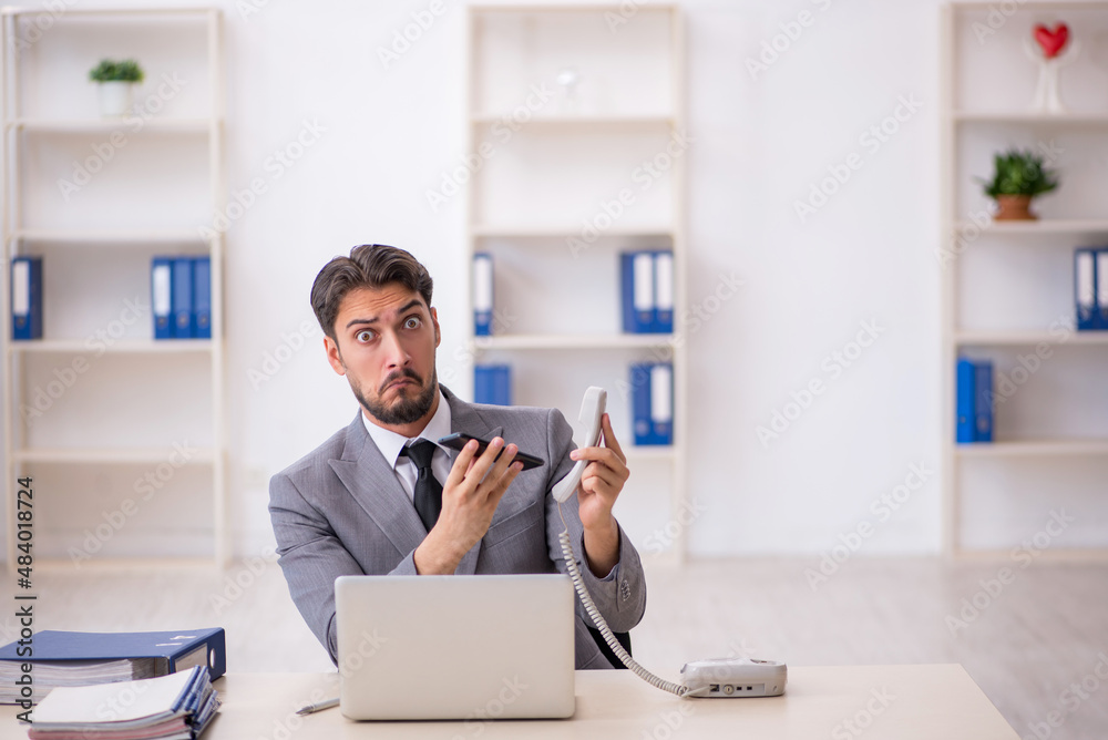 Young male employee working in the office Young male employee working in the office