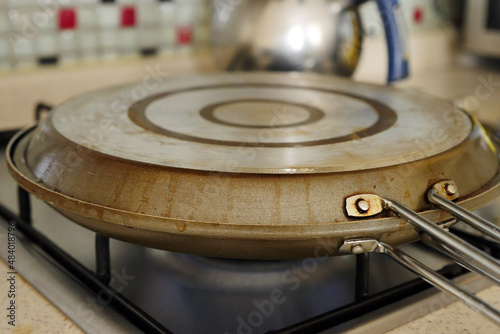 Fish are cooking in a closed fish pan, double-sided fish pan on the stove,