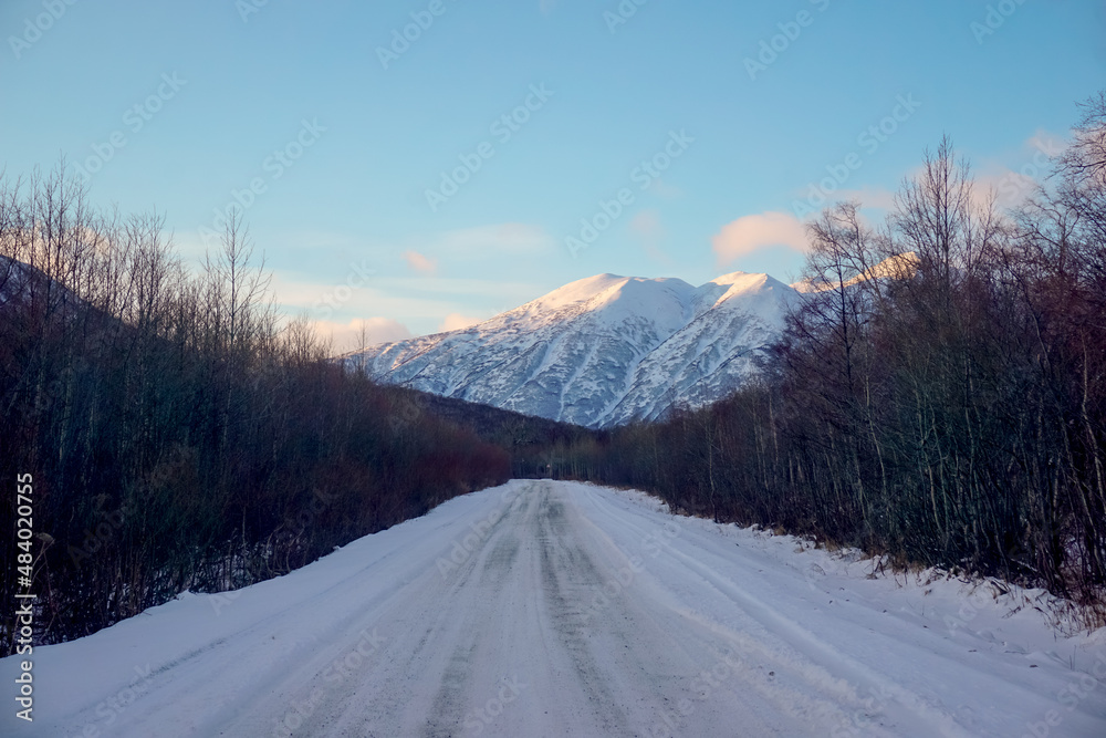 Snowy road with mountain landscape