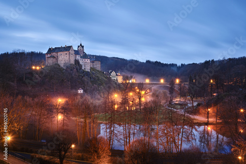 View of Loket Castle under the light of street lamps