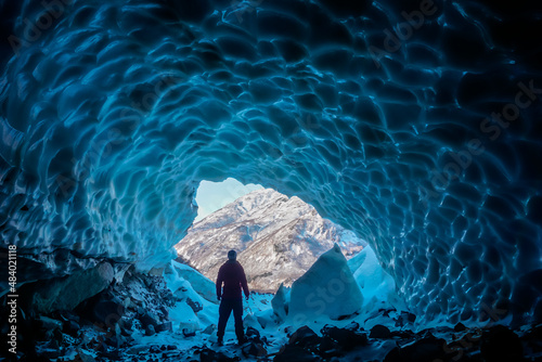 Man inside an ice cave photo