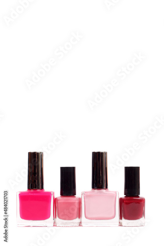 Pink and red nail polish shades, white background, copy space © lanych