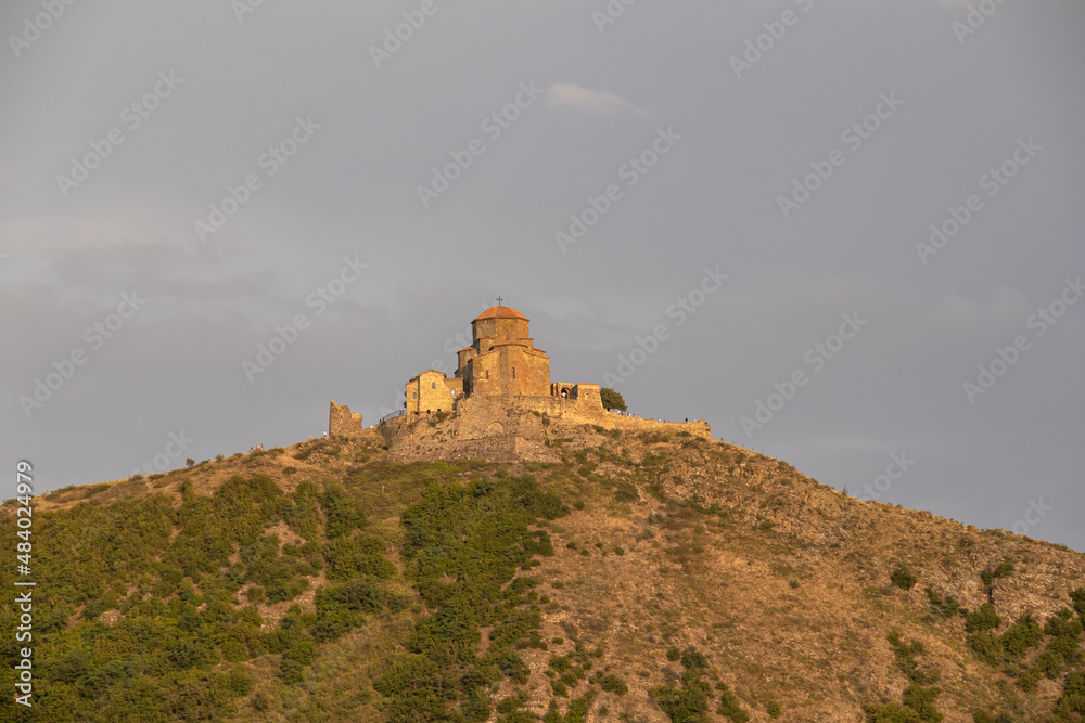 Panoramic view of Mtskheta Jvari monastery in Georgia. View to mountain hill with ancient walls. Famous orthodox monastery in the mountain. Ancient monastery on the hill.Travel concept.