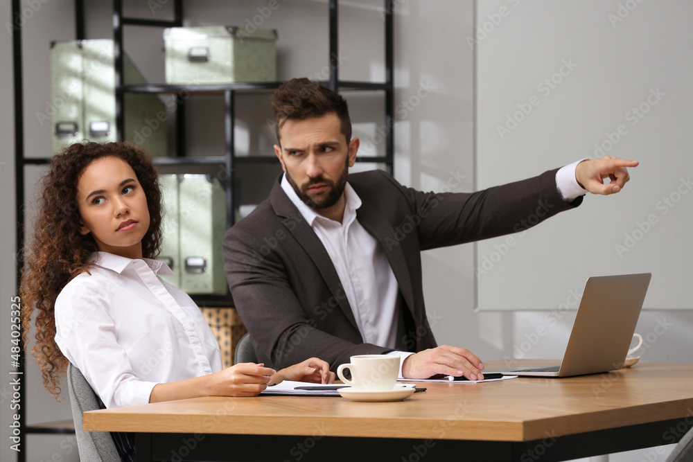 African American woman suffering from racial discrimination at work African American woman suffering from racial discrimination at work