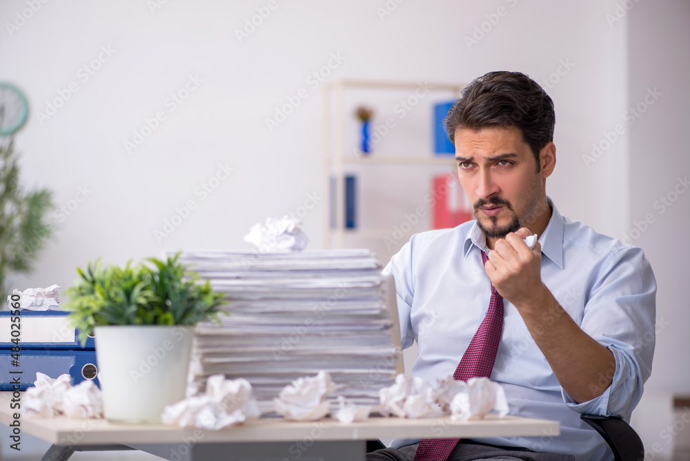 Young male employee in rejected ideas concept Young male employee in rejected ideas concept