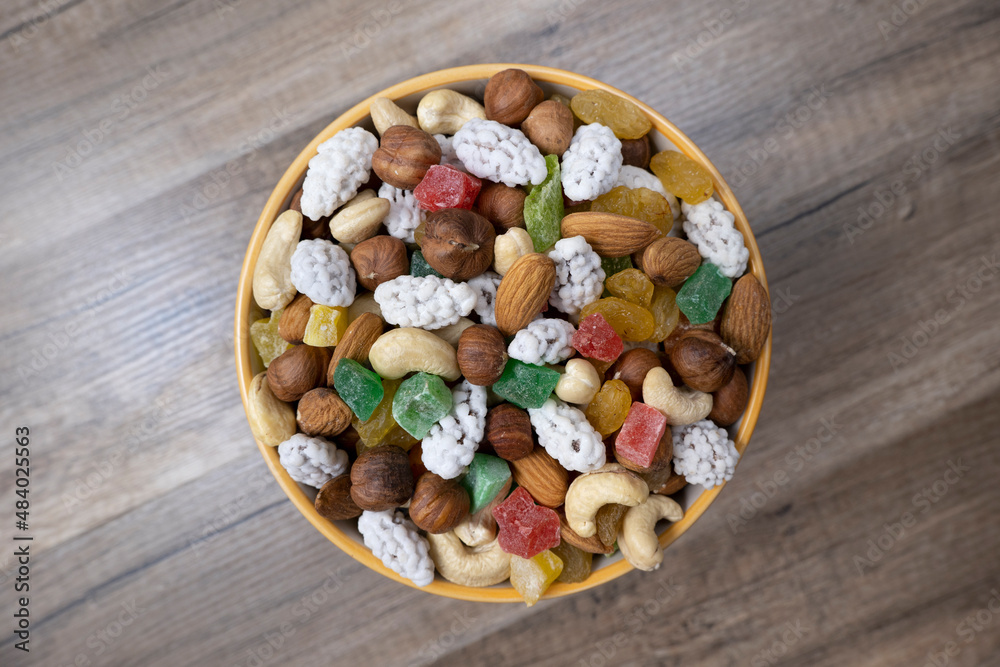 Sweets, raisin, candied fruit and nuts in a bowl on a table. Sweets, raisin, candied fruit and nuts in a bowl on a table.