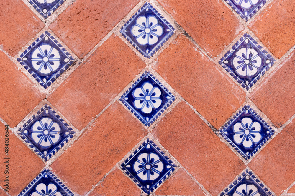 A traditional brick and talavera tiles wall in Puebla city, Mexico A traditional brick and talavera tiles wall in Puebla city, Mexico
