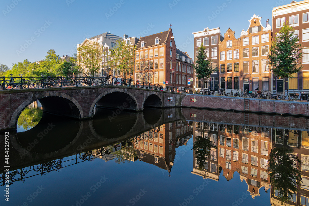 Reflections in the Keizersgracht canal on a quiet summer morning in Amsterdam