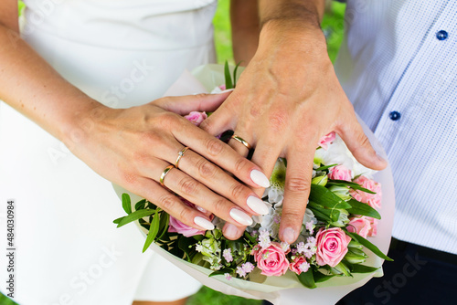 A pair of gold rings for wedding ceremony on bride and groom hands