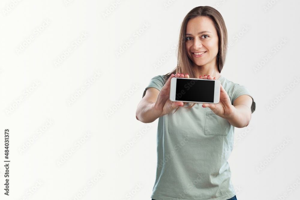 Portrait photo of young beautiful woman feeling happy or surprise shock and holding smart phone Portrait photo of young beautiful woman feeling happy or surprise shock and holding smart phone