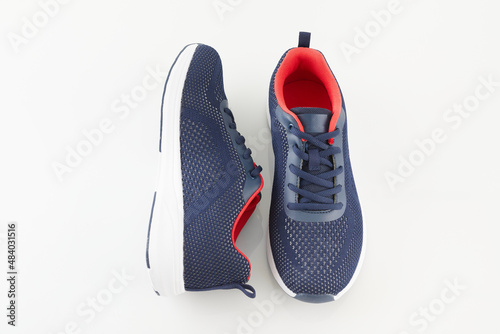 Pair of new unbranded blue running shoes or sneakers isolated on white background. Fashion sport footwear or trainers for fitness.