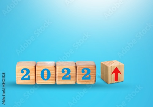 Wooden blocks with new year 2022, arrow up icons, Business development and growth concept