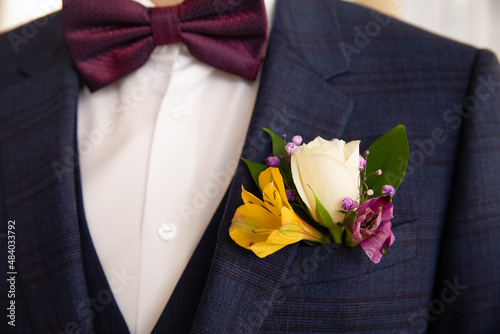 Beautiful boutonniere of the groom. Design a boutonniere. Wedding day photo