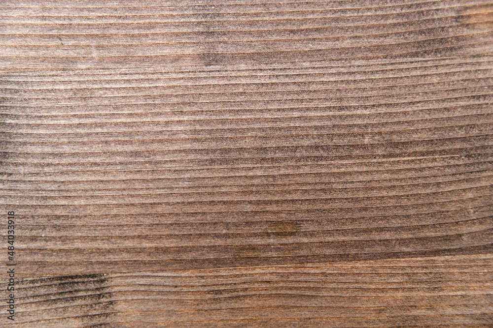 Wooden table structure covered with wood stain. Texture for design solutions